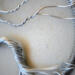 detailed wire art featuring a silver tree with twisted roots and branches inside a circular rustic frame focysing on trunk and branch